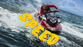 A rider on a Sea-Doo RXP-X jet ski PWC kicks up spray.