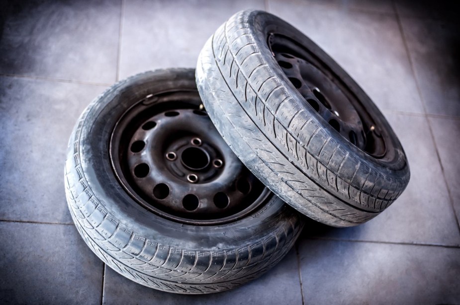 Two tires with bald tread from overinflation.