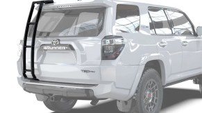 White Toyota 4Runner TRD Pro SUV with an aftermarket roof ladder.