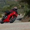 A person on a motorcycle going around a curve