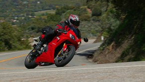 A person on a motorcycle going around a curve