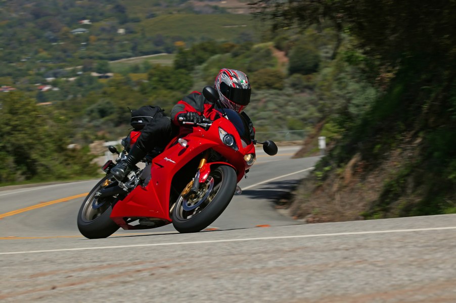 A person on a motorcycle going around a curve