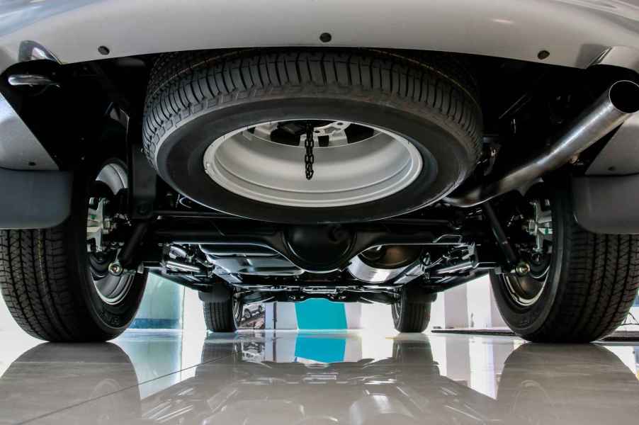 A spare tire mounted under the rear of a vehicle