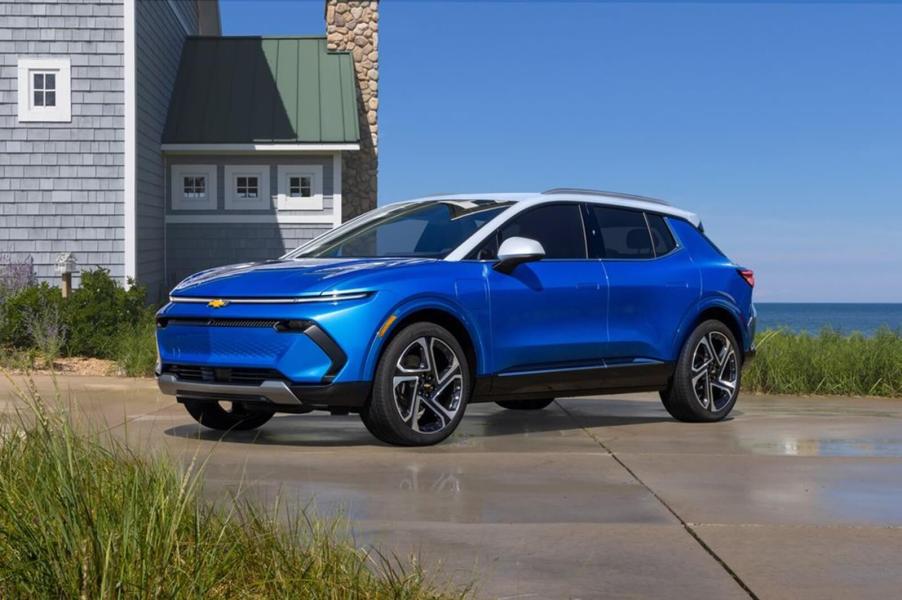 A Chevrolet Equinox EV 3LT, one of the American EVs that qualifies for the federal tax credit, parks next to a beach house.