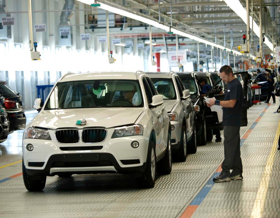 Row of 2010 BMW X3 crossovers on a production assembly line in South Carolina