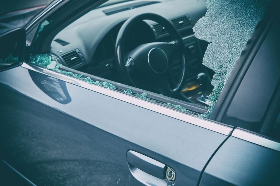 A thief steals a gun and valuable from a car, which likely won't be covered by car insurance.