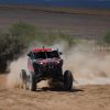 Craig Scanlon kicks up dirt in a red Polaris Factory Racing RZR Pro R Factory model.