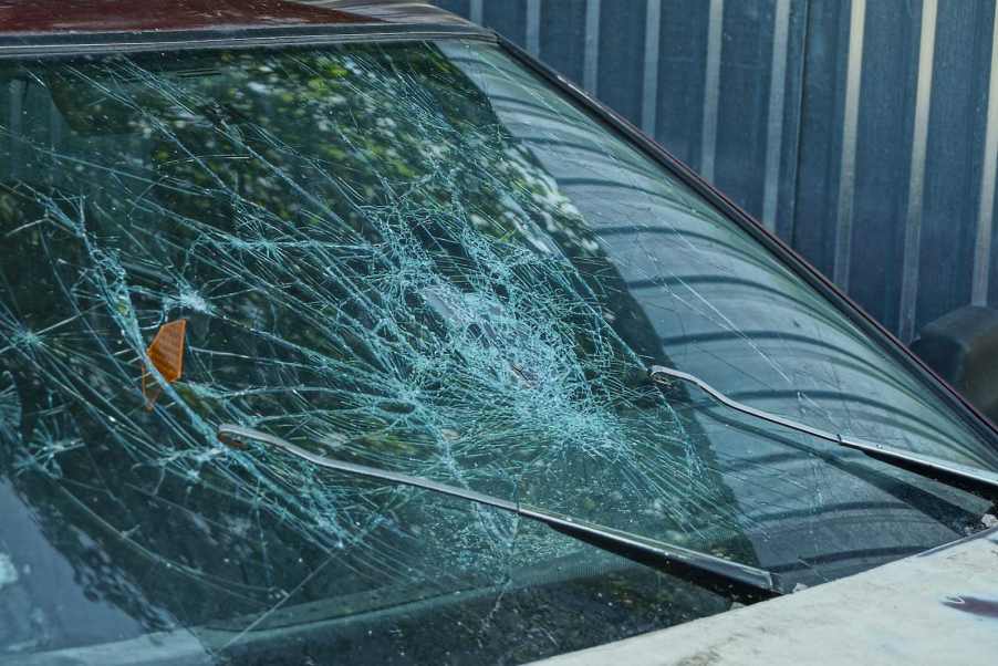 The smashed windshield of a crashed car.