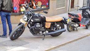 Moto Guzzi cafe racer parked on the sidewalk in Spain