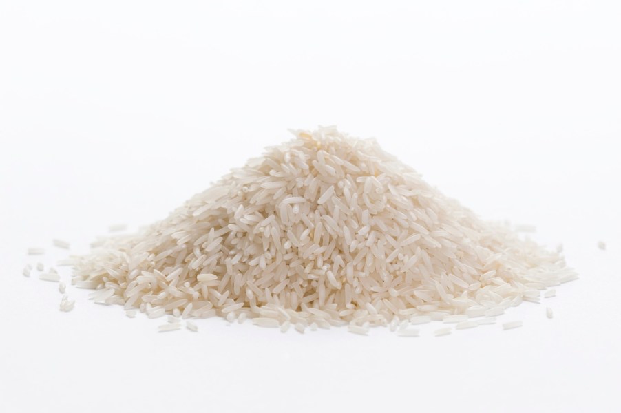 Pile of cooked white rice on a white background.