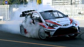 White Gazoo Racing Toyota Yaris does a burnout on a race track.