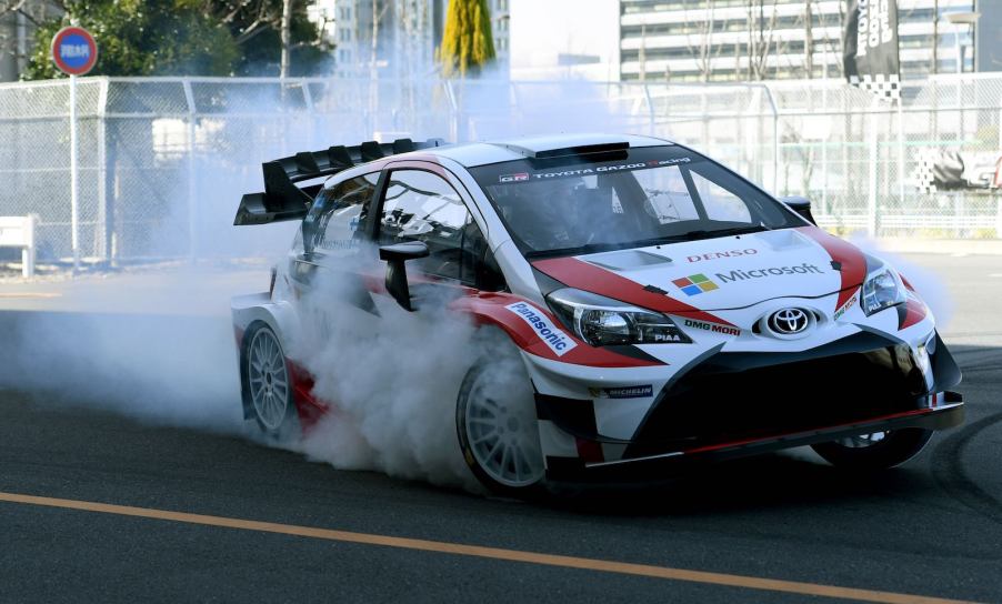 White Gazoo Racing Toyota Yaris does a burnout on a race track.