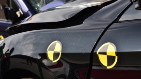 Black car's fender during crash safety test.