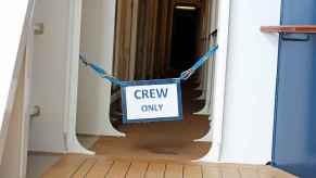 "Crew Only" sign posted in the hallway of a cruise ship.