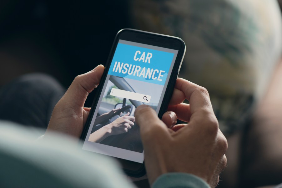 A man using a car insurance app on his phone