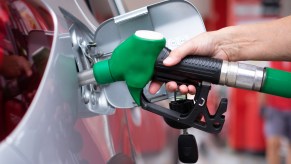 A woman filling a car with gas