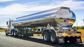 Tanker truck driving on the highway in left rear angle view