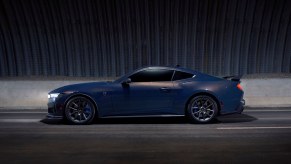 A modern muscle car, the Ford Mustang Dark Horse, shows off its side profile.