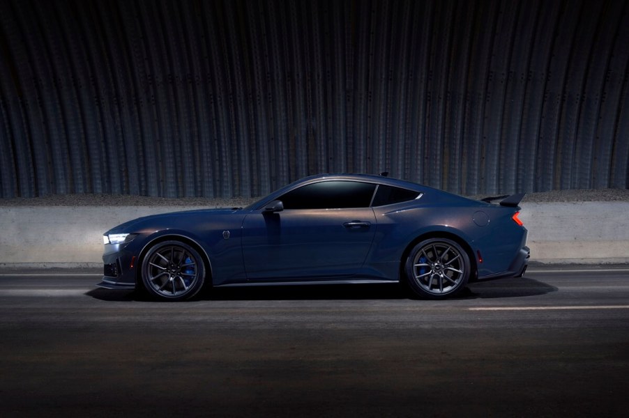 A modern muscle car, the Ford Mustang Dark Horse, shows off its side profile.