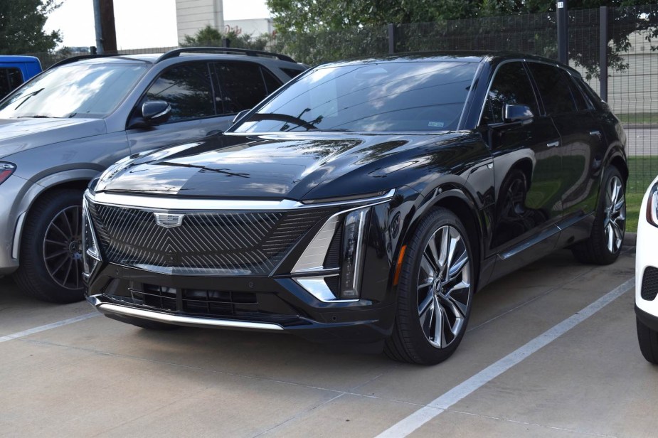 Black Cadillac Celestiq EV in a dealership parking lot.