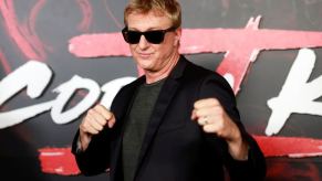 Cobra Kai star William Zabka steps out of his Dodge Challenger and onto the red carpet at a Netflix event.