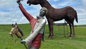 Two statues at a popular road trip stop in South Dakota.