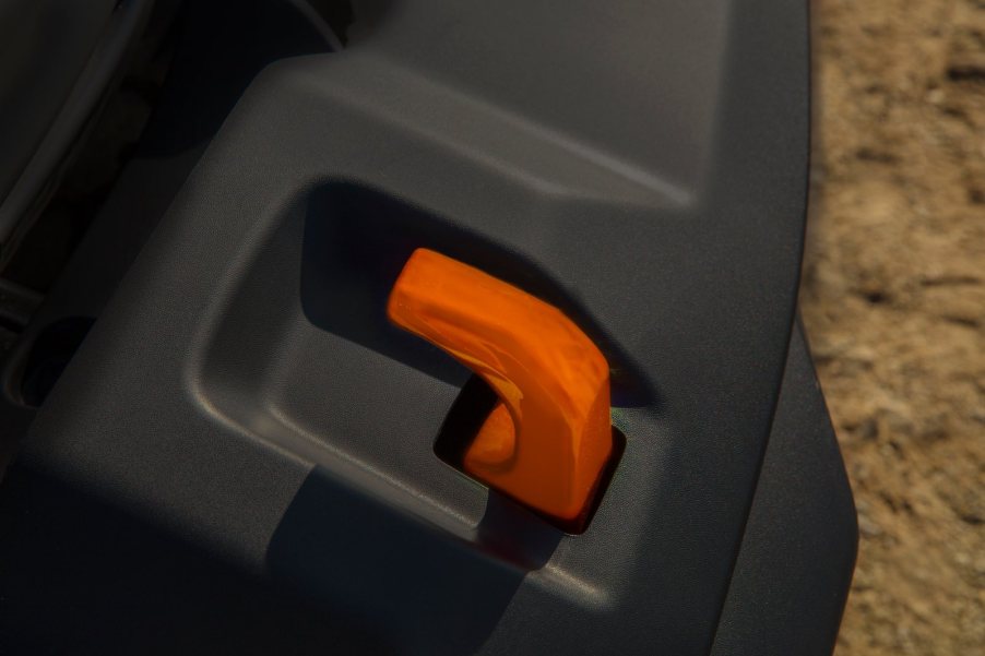 Reddish orange tow hook sticking out of the bumper of a Jeep Gladiator Mojave 4x4