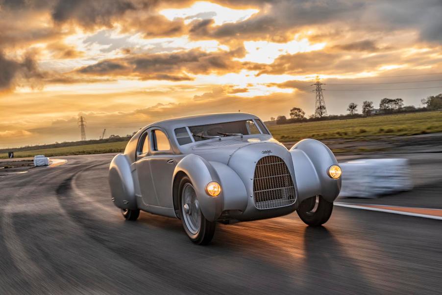 Audi's recreation of the Auto Union Type 52 mid-engine supercar design, driving in front of a sunset.