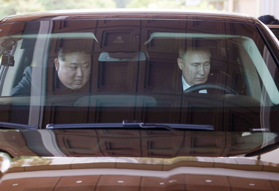 Kim Jong Un and Vladimir Putin driving a Aurus Senat car made in Russia.