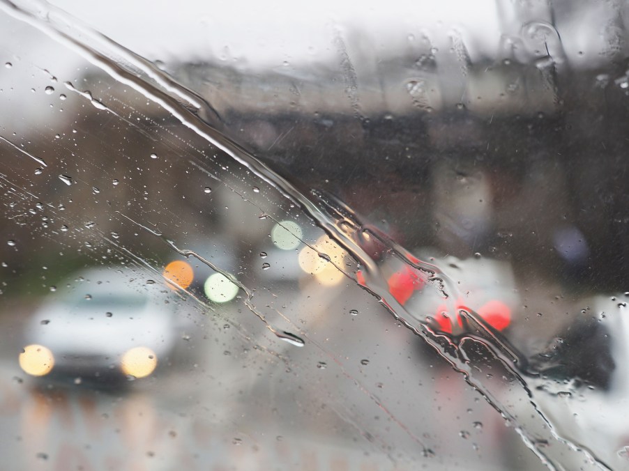 The view of a traffic jam during the rain through the windshield