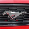 The front grille emblem on a 2012 Ford Mustang GT in very close view