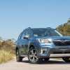 Blue 2018 Subaru Forester parked on a sandy trail.