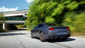 A Ford Mustang EcoBoost drives on a highway access road at speed.