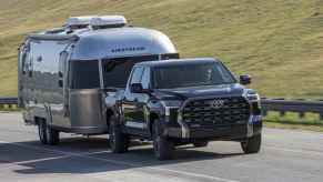 2024 Toyota Tundra shown towing an Airstream camper over 30K Toyota models recalled in 2024 over incorrect load carrying labels