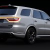 rear of a silver Dodge Durango SUV on a black background.