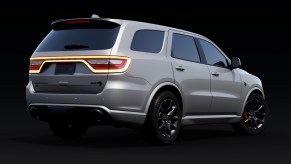 rear of a silver Dodge Durango SUV on a black background.