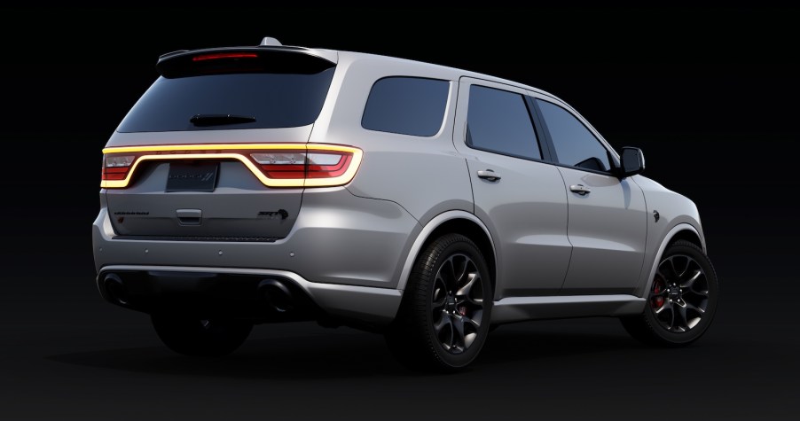 rear of a silver Dodge Durango SUV on a black background.