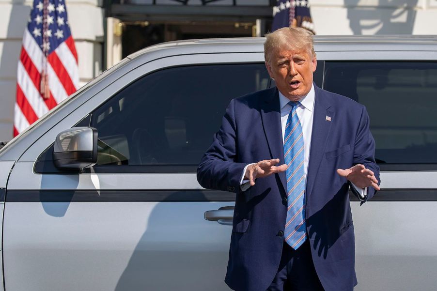 President Donald Trump gives a speech standing next to an electric truck.