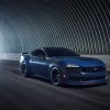 A new Ford Mustang Dark Horse drives through a tunnel.