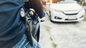 A motorcycle rider hits the road with an open carry handgun on his hip.