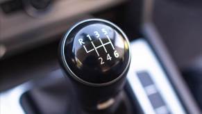 A manual gear shifter invites new drivers to learn how to drive a manual in 2024.