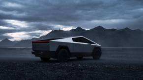 A Tesla Cybertruck in the desert under cloudy skies.