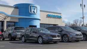 The exterior view of a Honda dealership with vehicles parked out front