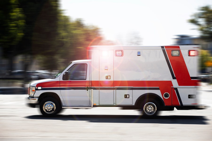 An ambulance speeding through an intersection