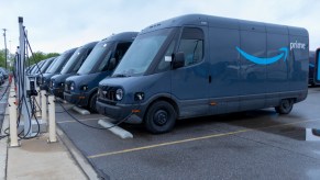 A fleet of Amazon Electric Deliver Vans charging