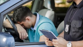 A man sad about getting a speeding ticket