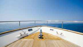 Looking out to see with coast in mid background from a yacht deck