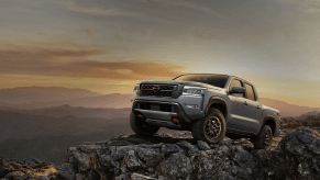 The 2024 Nissan Frontier climbing over rocks