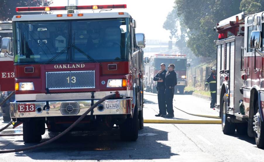 Oakland firefighters with their apparatuses and equipment, including the Jaws of Life.