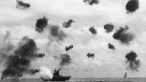 A US Navy ship, USS Yorktown, takes a hit at Midway during WWII.